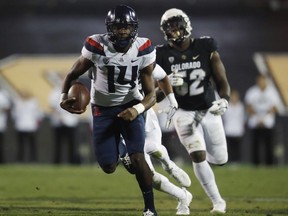 FILE - In this Oct. 7, 2017, file photo, Arizona quarterback Khalil Tate (14) runs for a touchdown in the second half of an NCAA college football game against Colorado, in Boulder, Colo. Tate was named the Pac-12 offensive player of the week for the fourth straight week on Monday, Oct. 30, 2017, a conference record. (AP Photo/David Zalubowski, File)