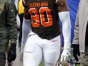 FILE - In this Nov. 19, 2017, file photo, Cleveland Browns defensive end Emmanuel Ogbah (90) walks into the locker room in the first half of an NFL football game against the Jacksonville Jaguars, in Cleveland. Ogbah needs surgery on his broken right foot and will require up to four months of recovery. Ogbah said Monday, Nov. 20, 2017, that he suffered a non-contact injury in Sunday's 19-7 loss to Jacksonville. (AP Photo/Ron Schwane, File)