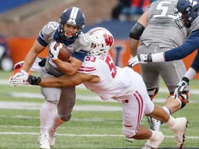 FILE - In this Oct. 28, 2017, file photo, Wisconsin linebacker T.J. Edwards (53) tackles Illinois running back Kendrick Foster (22) during the first half of an NCAA college football game in Champaign, Ill. No. 5 Wisconsin will face its sternest test yet this season when No. 19 Michigan visits Camp Randall Stadium in the home season finale. (AP Photo/Bradley Leeb, File)