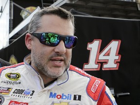 FILE - In this Nov. 19, 2016, file photo, Tony Stewart heads to the hauler after a NASCAR Sprint Cup Series Auto Racing practice in Homestead, Fla. Tony Stewart hasn't ruled out a return in some form to NASCAR, perhaps in the Xfinity Series or at Charlotte Motor Speedway's road course. The three-time NASCAR champion expressed interest in getting back in a stock car Wednesday, Nov. 8, 2017, as he introduced Aric Almirola as the newest driver at Stewart-Haas Racing. (AP Photo/Alan Diaz, File)