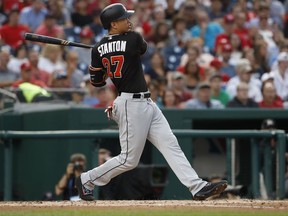 FILE - In this Aug. 10, 2017, file photo, Miami Marlins' Giancarlo Stanton (27) watches his two-run home run during the third inning of the team's baseball game against the Washington Nationals in Washington. Houston dynamo Jose Altuve and Yankees slugger Aaron Judge are the favorites for the AL MVP award while Miami masher is the top candidate for the NL prize. (AP Photo/Carolyn Kaster, File)