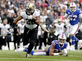 FILE - In this Nov. 12, 2017, file photo, New Orleans Saints running back Mark Ingram II (22) runs with the ball during the first half of an NFL football game against the Buffalo Bills,in Orchard Park, N.Y. As usual, Drew Brees has the passing game humming, and the contributions of the running back tandem of Mark Ingram and rookie Alvin Kamara has made New Orleans even more dynamic with the ball. The Washington Redskins play at New Orleans on Sunday. (AP Photo/Adrian Kraus, File)