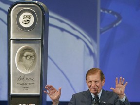 FILE - In this May 23, 2011, file photo, Bud Moore acknowledges the crowd after being inducted into the NASCAR Hall of Fame during a ceremony in Charlotte, N.C. NASCAR Hall of Famer Bud Moore, a World War II veteran awarded five Purple Hearts and two Bronze Stars, has died. He was 92. NASCAR announced the death of Moore, born Walter Moore Jr., on Tuesday, Nov. 28, 2017. No details were given, but Moore lived in Spartanburg, South Carolina. (AP Photo/Terry Renna, File)