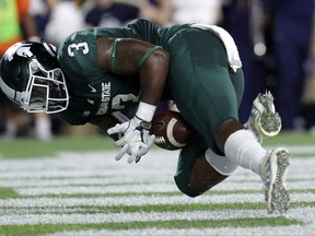 FILE - In this Sept. 23, 2017, file photo, Michigan State's LJ Scott tries unsuccessfully to recover his fumble in the end zone during the second quarter against Notre Dame in an NCAA college football game in East Lansing, Mich. The fumbling problems that plagued the Spartans early this season haven't really gone away, and they finally lost a Big Ten game last weekend at Northwestern. (AP Photo/Al Goldis, File)
