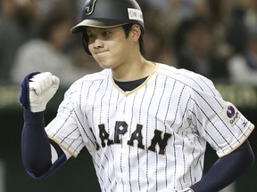 FILE - In this Nov. 12, 2016, file photo, Japan's designated hitter Shohei Otani reacts after hitting a solo home run off Netherlands' starter Jair Jurrjens in the fifth inning of their international exhibition series baseball game at Tokyo Dome in Tokyo. Texas, the New York Yankees and Minnesota can pay the most to an international free agent as highly touted pitcher-outfielder Shohei Otani prepares to enter the market, and Major League Baseball and its Japanese counterpart have agreed to the outlines of a deal to keep the old posting system for this offseason. (AP Photo/Koji Sasahara, File)