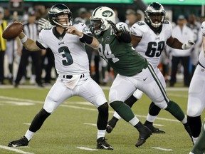 In this Thursday, Aug. 31, 2017 file photo, New York Jets defensive lineman Kony Ealy, right, moves in to sack Philadelphia Eagles quarterback Matt McGloin during the first half of an NFL football game in East Rutherford, N.J. Kony Ealy is downplaying the obvious story line now. Sure, the defensive lineman was a Super Bowl star with the Carolina Panthers two seasons ago and then got traded last March. Ealy is with the New York Jets these days, and insists that his past won't affect his approach.(AP Photo/Michael Noble Jr, File.)