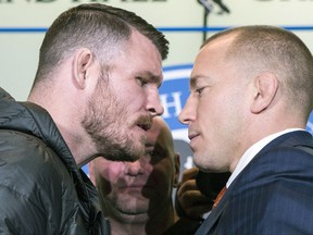 FILE - In this Oct. 13, 2017, file photo, Britain's Michael Bisping, left, and Canada's Georges St. Pierre face off during a news conference in Toronto, to promote their upcoming UFC 217. At center rear is UFC President Dana White. The pair square off on Saturday at Madison Square Garden in New York. (Chris Young/The Canadian Press via AP, File)