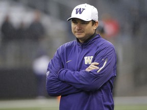 In this Saturday, Nov. 7, 2015 file photo, Washington offensive coordinator and quarterbacks coach Jonathan Smith looks on during warmups before an NCAA college football game against Utah in Seattle. A person with direct knowledge of the decision says Oregon State has hired Washington co-offensive coordinator Jonathan Smith to be its new head coach. The person spoke to The Associated Press on Wednesday, Nov. 29, 2017 on condition of anonymity because an official announcement was being finalized. (AP Photo/Ted S. Warren, File)