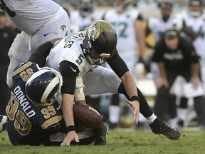 FILE - In this Oct. 15, 2017, file photo, Jacksonville Jaguars quarterback Blake Bortles (5) loses the ball as he is sacked by Los Angeles Rams defensive tackle Aaron Donald (99) during the second half of an NFL football game, in Jacksonville, Fla. Aaron Donald of the Los Angeles Rams is the unanimous choice by an Associated Press panel as the best defensive tackle in the NFL. (AP Photo/Phelan M. Ebenhack, File)