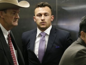 FILE - In this Feb. 28, 2017, file photo, former NFL quarterback Johnny Manziel, center, takes an elevator with his lawyer Jim Darnell, left, after a court hearing in Dallas. Prosecutors in Dallas have dismissed a 2016 misdemeanor domestic assault charge against Heisman Trophy-winning quarterback Johnny Manziel. The Dallas County District Attorney's Office on Thursday, Nov. 30, 2017, confirmed Manziel successfully completed requirements of a court agreement that included taking an anger management course and participating in the NFL's substance abuse program.(AP Photo/LM Otero, File)
