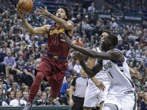 FILE - In this Oct, 20, 2017, file photo, Cleveland Cavaliers' Derrick Rose, left, drives to the basket as Milwaukee Bucks' Thon Maker, right, defends during the first half of an NBA basketball game in Milwaukee. Rose will miss at least the next two weeks with a nagging left ankle injury. He injured the ankle Oct. 20 at Milwaukee and has missed Cleveland's past four games. He underwent medical tests and was recommended to rest. (AP Photo/Tom Lynn, File)