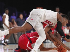 SMU guard Jarrey Foster (10) and Arizona guard Parker Jackson-Cartwright (0) scramble for possession during an NCAA college basketball game Thursday, Nov. 23, 2017, in the Battle 4 Atlantis tournament in Paradise Island, Bahamas. (Tim Aylen/Bahamas Visual Services Photo via AP)