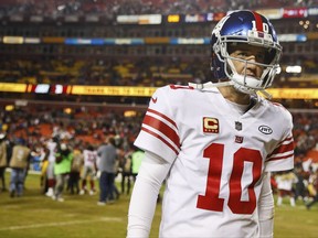 FILE - In this Nov. 23, 2017, file photo, New York Giants quarterback Eli Manning (10) walks off the field after a 2010 loss to the Washington Redskins, in an NFL football game in Landover, Md. The Giants are changing quarterbacks for first time in more than 13 years. Yes, Eli Manning is not going to start. The Giants announced on Tuesday, Nov. 28, 2017, that Geno Smith will start in place of Manning when the Giants (2-9) face the Raiders in Oakland on Sunday. (AP Photo/Patrick Semansky, File)