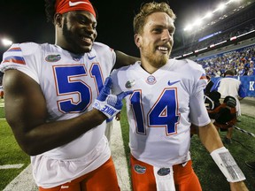 FILE - In this Sept. 23, 2017, file photo, Florida offensive lineman Antonio Riles, left, celebrates with quarterback Luke Del Rio after an NCAA college football game against Kentucky in Lexington, Ky. Injured Florida quarterback Luke Del Rio has decided to end his "unique" college career. Del Rio posted on his Twitter page Wednesday, Nov. 22, 2017, that he will be participating in "Senior Day" activities before the team's season finale Saturday against rival Florida State. (AP Photo/David Stephenson, File)