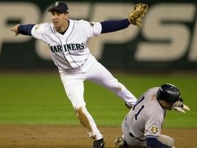 FILE - In this Oct. 18, 2001, file photo, Seattle Mariners second baseman Brett Boone signals the out as he catches New York Yankees' Chuck Knoblauch stealing during the second inning of Game 2 of the American League Championship Series in Seattle. Former Seattle second baseman Boone apologized Wednesday, Nov. 29, 2017, for making light of sexual harassment in a message to a reporter. "All, there are zero excuses for what I said earlier," he wrote on his Twitter feed. "None. It was 100% wrong. It was offensive. It was inappropriate. It was not remotely productive to any conversation regarding harassment. I apologize and it will never happen again." (AP Photo/Elaine Thompson, File)
