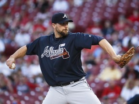 In this Saturday, June 3, 2017 file photo, Atlanta Braves relief pitcher Jim Johnson throws in the 12th inning of a baseball game against the Cincinnati Reds in Cincinnati. The Los Angeles Angels have acquired pitcher Jim Johnson and the Atlanta Braves' remaining $1.21 million in international bonus signing allocation for minor league left-hander Justin Kelly, a deal that raises Los Angeles' possible bonus offer to Shohei Ohtani to $1,315,000. (AP Photo/John Minchillo, File)