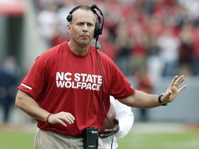 In this Saturday, Nov. 4, 2017 file photo, North Carolina State head coach Dave Doeren reacts during the first half of an NCAA college football game against Clemson in Raleigh, N.C. A person with knowledge of the situation says North Carolina State and Dave Doeren have agreed on a five-year deal after the coach had talked with Tennessee officials about the school's opening. The person spoke to The Associated Press Thursday, Nov. 30, 2017 on condition of anonymity because N.C. State hasn't publicly announced the agreement. (AP Photo/Gerry Broome, File)