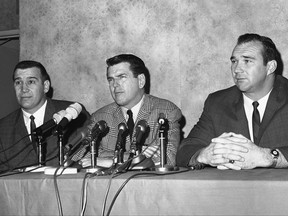 FILE - In this January 1966 file photo, George Allen, defensive coach of the Chicago Bears who was hired as head coach of the Los Angeles Rams, is flanked by two Bear defensive stars, Joe Fortunato, left, and Doug Atkins, at a Los Angeles news conference announcing his new job in Los Angeles. Fortunate and Atkins, staying at the hotel where the conference took place, dropped in to voice approval of Allen's ability. Fortunato, the speedy linebacker who helped the Bears win the 1963 NFL title, has died. He was 87. Fortunato died Monday, Nov. 6, 2017, in Mississippi, where he starred at linebacker and fullback at Mississippi State. (AP Photo/File)
