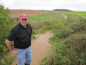 In this Sept. 13, 2016 photo, Brent Peterson, who promotes runoff prevention in eastern Wisconsin's Lower Fox River watershed, stands beside a creek in Brown County, Wis. The Fox River empties into the algae-plagued Green Bay, which contains less than 2 percent of Lake Michigan's water but receives one-third of the entire lake's nutrient flow. (AP Photo/John Flesher)