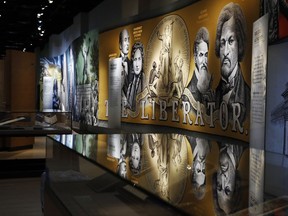 An exhibit discussing slavery and the Bible in the United States is displayed inside the Museum of the Bible, Monday, Oct. 30, 2017, in Washington. The museum was built by the owners of Hobby Lobby, cost $500 million to build, covers 430,000 square feet and is a few blocks from the U.S. Capitol. (AP Photo/Jacquelyn Martin)