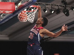 In this photo provided by Bahamas Visual Services, Arizona guard Allonzo Trier (35) slam-dunks against Purdue during an NCAA college basketball game Friday, Nov. 24, 2017, at the Battle 4 Atlantis tournament in Paradise Island, Bahamas. (Tim Aylen/Bahamas Visual Services Photo via AP)