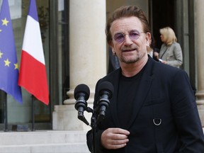 FILE - In this July 24, 2017, file photo, U2 singer Bono speaks to the media after a meeting at the Elysee Palace, in Paris, France. Bono will break a longstanding promise among the band not to play golf in order to raise money for his (RED) charity in the fight against HIV/AIDS. The chance to play mini-golf with U2 is just one of the celebrity experiences that are being raffled off as part of the (RED) Shopathon campaign for World AIDS Day on Dec. 1 at Omaze.com/RED. (AP Photo/Michel Euler, File)