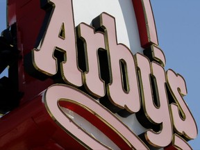 FILE - This March 1, 2010, file photo shows an Arby's restaurant sign in Cutler Bay, Fla. Arby's is buying casual dining chain Buffalo Wild Wings in a deal worth about $2.4 billion. Arby's Restaurant Group Inc. said Tuesday, Nov. 28, 2017, that it will pay $157 per share. (AP Photo/Wilfredo Lee, File)