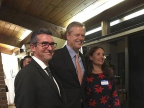 In this Oct. 23, 2017 photo provided by Tom Mountain, Martin Marro, left, and his wife, Mariana Dagatti, right, pose for a photo with the Massachusetts Gov. Charlie Baker in Newton, Mass. The Argentine foreign ministry said Marro is recovering from his injuries at a Manhattan hospital after the Tuesday, Oct. 31 bike path attack. (Tom Mountain via AP)