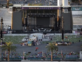 FILE - In this Tuesday, Oct. 3, 2017, file photo, debris litters a concert festival grounds after a mass shooting in Las Vegas. Legal action stemming from the mass shooting at the concert is picking up with lawsuits filed Wednesday, Nov. 15, on behalf of 14 concertgoers. (AP Photo/John Locher, File)