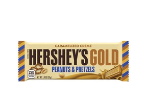 This image released by The Hershey Company shows their new candy bar Hershey's Gold that will go on sale Dec. 1, 2017. It's described as a caramelized cream bar embedded with salty peanut and pretzel bits. (The Hershey Company via AP)