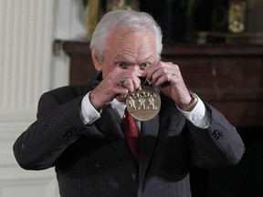 FILE - In this Feb. 13, 2012, file photo, country music singer Mel Tillis holds up his 2011 National Medal of the Arts after it was presented to him by President Barack Obama, in the East Room of the White House in Washington. Tillis, the longtime country star who wrote hits for Kenny Rogers, Ricky Skaggs and many others, and overcame a stutter to sing on dozens of his own singles, has died. A spokesman for Tillis, Don Murry Grubbs, said Tillis died early Sunday, Nov. 19, 2017, at Munroe Regional Medical Center in Ocala, Fla. He was 85. (AP Photo/Pablo Martinez Monsivais, File)