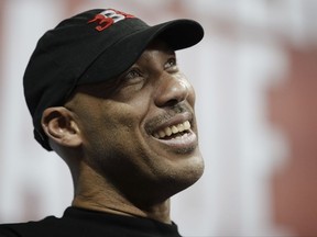 FILE - In this July 7, 2017, file photo, LaVar Ball, father of Los Angeles Lakers' Lonzo Ball and UCLA player LiAngelo Ball, watches the Lakers play the Los Angeles Clippers during an NBA summer league basketball game, in Las Vegas. President Donald Trump tweeted Sunday, Nov. 19, that he should have left three UCLA basketball players, including LiAngelo Ball, accused of shoplifting in China in jail after LaVar Ball minimized Trump's involvement in winning the players' release during an interview Saturday, Nov. 18, with ESPN. (AP Photo/John Locher, File)