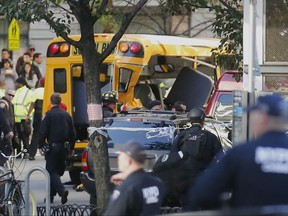 Authorities respond near a damaged school bus Tuesday, Oct. 31, 2017, in New York. A motorist drove onto a busy bicycle path near the World Trade Center memorial and struck several people on Tuesday police and witnesses said. (AP Photo/Bebeto Matthews)