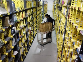 FILE - In this Tuesday, Dec. 22, 2015, file photo, Amazon Prime employee Alicia Jackson hunts for items at the company's urban fulfillment facility that have been ordered by customers, in New York. Shoppers are expected to spend $6.6 billion on Cyber Monday, Nov. 27, 2017, up more than 16 percent from a year ago, according to Adobe Analytics, the research arm of software maker Adobe. And more people will be picking up their phones to shop: Web traffic from smartphones and tablets is expected to top desktop computers for the first time this year, Adobe said. (AP Photo/Mark Lennihan, File)