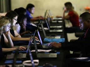FILE - In this Friday, May 19, 2017, file photo, job seekers work on their resumes during the Opportunity Fair and Forum employment event in Dallas. On Thursday, Nov. 2, 2017, the Labor Department reports on the number of people who applied for unemployment benefits a week earlier. (AP Photo/LM Otero, File)