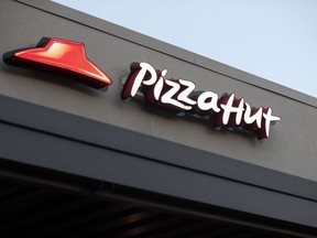 FILE - This Thursday, Dec. 15, 2016, file photo shows a Pizza Hut restaurant in New Orleans. On Thursday, Nov. 2, 2017, Yum Brands said it saw a key sales measure rise at KFC, Pizza Hut and Taco Bell for the third quarter, and said it saw no effect on sales due to declining NFL viewership, a day after Papa John's blamed weaker pizza sales on the controversy over protests during the national anthem. (AP Photo/Gerald Herbert, File)