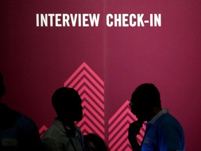 FILE - In this Friday, May 19, 2017, file photo, job seekers chat during the Opportunity Fair and Forum employment event in Dallas. It's tough to come up with the right answer in a job interview, particularly if the question could run afoul of the law. An Associated Press-CNBC poll found that half of all Americans who've ever applied for a job have been asked questions that could be used to discriminate. (AP Photo/LM Otero, File)