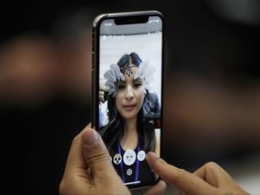 In this Tuesday, Sept. 12, 2017, photo, the new iPhone X is displayed in the showroom after the new product announcement in Cupertino, Calif. The iPhone X's lush screen, facial-recognition skills and $1,000 price tag are breaking new ground in Apple's marquee product line. (AP Photo/Marcio Jose Sanchez)