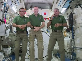 In this undated image provided by NASA,  NASA astronauts Joe Acaba, left, Randy Bresnik, center, and Mark Vande Hei give interviews on the International Space Station. The trio along with their international crewmates plan to feast on pouches of Thanksgiving turkey and single-serving bags of sides on Thursday, Nov. 23, 2017. (NASA via AP)