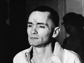 FILE - In this March 12, 1971 file photo, Charles Manson, with a swastika on his forehead, walks to court in Los Angeles, during the the penalty phase of the Sharon Tate trial after being convicted of murder in the deaths of Tate and six others. Authorities say Manson, cult leader and mastermind behind 1969 deaths of actress Sharon Tate and six others, died on Sunday, Nov. 19, 2017. He was 83. (AP Photo, File)