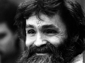 FILE - In this Feb. 4, 1986, file photo, convicted murderer Charles Manson looks towards the parole board in San Quentin, Calif. Authorities say Manson, cult leader and mastermind behind 1969 deaths of actress Sharon Tate and several others, died on Sunday, Nov. 19, 2017. He was 83.(AP Photo/Eric Risberg, File)