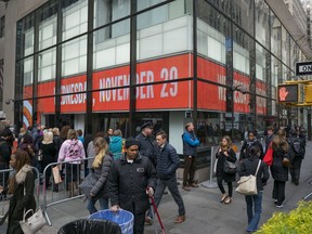 People stand at the windows and also pass by the set of the "Today" show during the broadcast on Wednesday, Nov. 29, 2017, in New York.