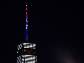 As ordered by New York Gov. Andrew Cuomo, the spire of One World Trade Center is illuminated in red, white and blue following a deadly rampage down a bike path not far from the building Tuesday, Oct. 31, 2017, in New York. A motorist in a rented Home Depot truck drove onto a bike path, striking and killing several people. (AP Photo/Craig Ruttle)