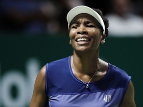 FILE - In this Oct. 28, 2017, file photo, Venus Williams, of the United States, reacts after conceding a point to Caroline Garcia, of France, during their semifinal match at the WTA tennis tournament in Singapore. Burglars hit the tennis star's Florida home, stealing $400,000 worth of goods while she was at the U.S. Open. Palm Beach Gardens police released a report Thursday, Nov. 16, 2017, about the burglary, which happened between Sept. 1 and 5. (AP Photo/Yong Teck Lim, File)