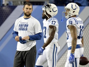 FILE - In this Oct. 16, 2017, file photo, injured Indianapolis Colts quarterback Andrew Luck watches as teammates warm up before an NFL football game against the Tennessee Titans in Nashville, Tenn. The Colts will place Luck on the season-ending injured reserve list. (AP Photo/Mark Zaleski, File)