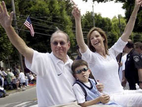 FILE - In this June 8, 2003, file photo, parade grand marshal Syracuse basketball coach Jim Boeheim, left, waves to fans with his wife, Juli, and son, Jimmy during the International Boxing Hall of Fame Parade of Champions in Canastota, N.Y. When Boeheim leads Syracuse against Cornell on Friday night, he'll be secretly rooting for one of the guys on the opposing bench to do well, just not well enough to upset the Orange. That player is Boeheim's oldest son Jimmy, a freshman forward for the Big Red. (AP Photo/Kevin Rivoli, File)
