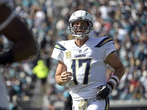 FILE - In this Sunday, Nov. 12, 2017, file photo, Los Angeles Chargers quarterback Philip Rivers shouts to teammates during the first half of an NFL football game against the Jacksonville Jaguars in Jacksonville, Fla. Rivers is in the NFL's concussion protocol after experiencing possible symptoms of a head injury, endangering his streak of 194 consecutive starts since 2006. Rivers told the Chargers about his symptoms Monday after they returned from a 20-17 overtime loss in Jacksonville, coach Anthony Lynn said. (AP Photo/Phelan M. Ebenhack, File)