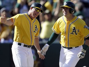 FILE - In this May 7, 2017, file photo, Oakland Athletics' Ryon Healy, right, celebrates with third base coach Chip Hale after hitting a walkoff two-run home run off Detroit Tigers' Francisco Rodriguez in the ninth inning of a baseball game in Oakland, Calif. Former major league skipper Chip Hale will be the bench coach for new Washington Nationals manager Dave Martinez, while Derek Lilliquist will be the team's pitching coach, the Nationals announced, Thursday, Nov. 9, 2017. Hale was Oakland's third base coach last season. Before that, he managed the Arizona Diamondbacks in 2015 and 2016. (AP Photo/Ben Margot, File)