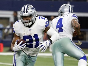 FILE - In this Sunday, Nov. 5, 2017, file photo, Dallas Cowboys running back Ezekiel Elliott (21) carries the ball after taking a hand off from quarterback Dak Prescott (4) during an NFL football game against the Kansas City Chiefs in Arlington, Texas. Elliott and the Cowboys are in legal limbo for the second straight week as the star running back fights his six-game suspension over alleged domestic violence. (AP Photo/Michael Ainsworth, File)