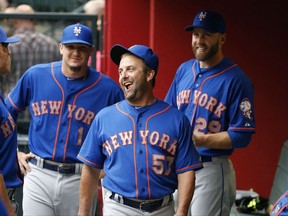 FILE - In this June 4, 2015, file photo, New York Mets hitting coach Kevin Long (57) jokes with Darrell Ceciliani (1) and Eric Campbell (29) in the dugout prior to a baseball game against the Arizona Diamondbacks in Phoenix. A person with knowledge of the deal tells The Associated Press that the Washington Nationals have agreed to hire Kevin Long as their new hitting coach. The person spoke on condition of anonymity on Thursday, Nov. 2, 2017, because the Nationals have not made any announcements about their new coaching staff. Long replaces Rick Schu as Washington's hitting coach. (AP Photo/Ross D. Franklin, File)